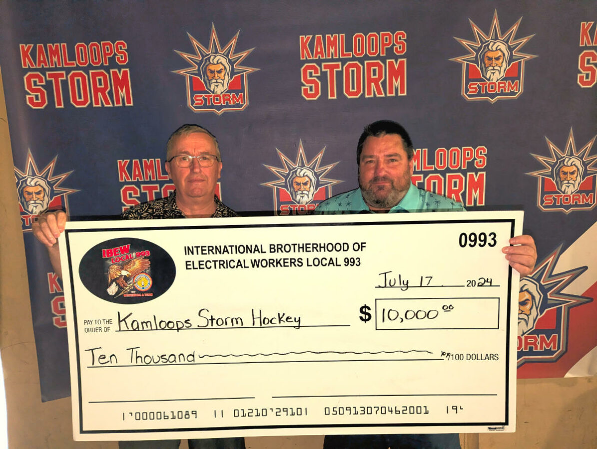 IBEW 993 Business Manager Jim Bicknell presenting a cheque for $10,000 to Matt Kolle of the Kamloops Storm