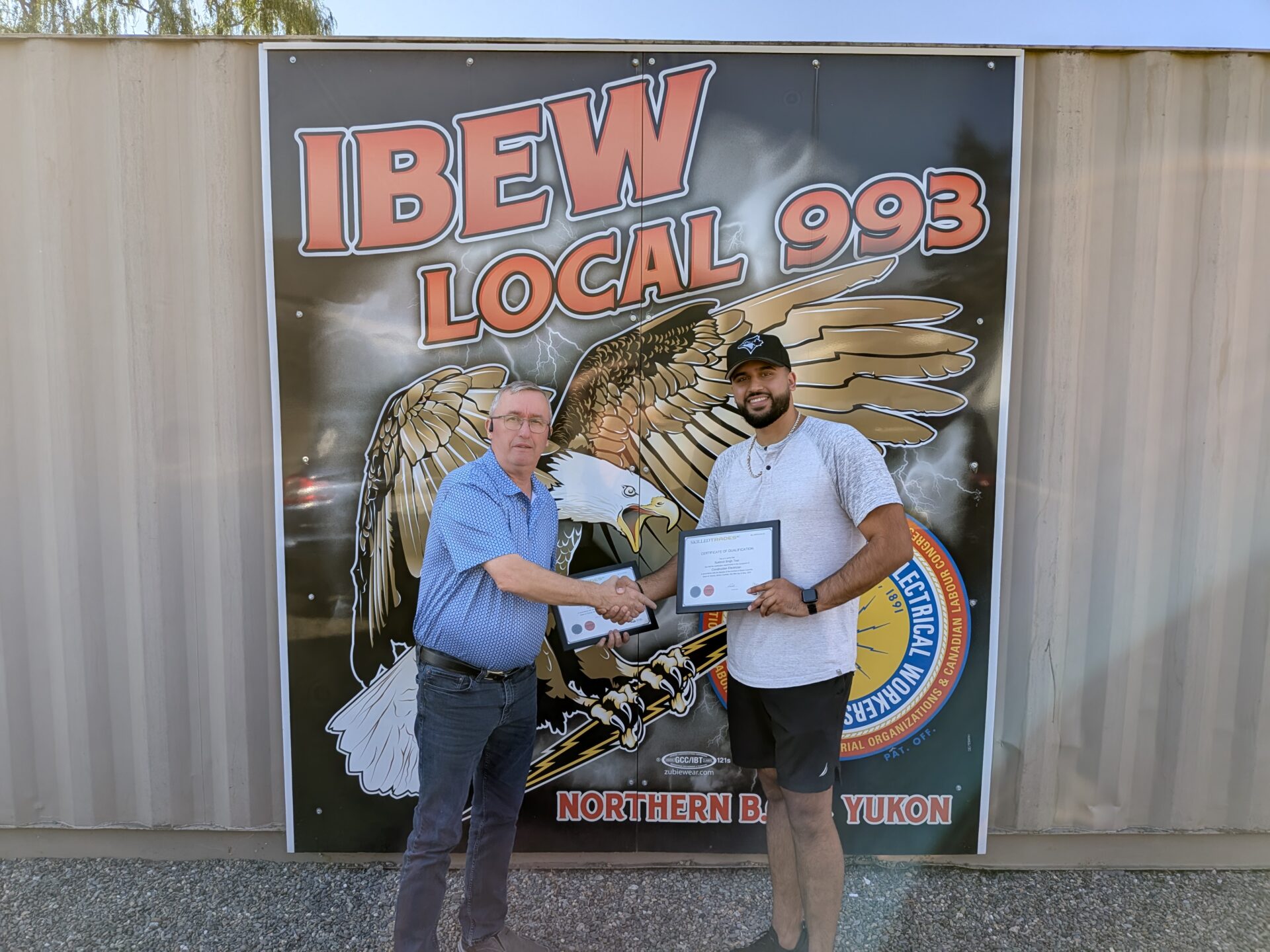 Sukhmit Toor receiving his Red Seal from Business Manager Jim Bicknell